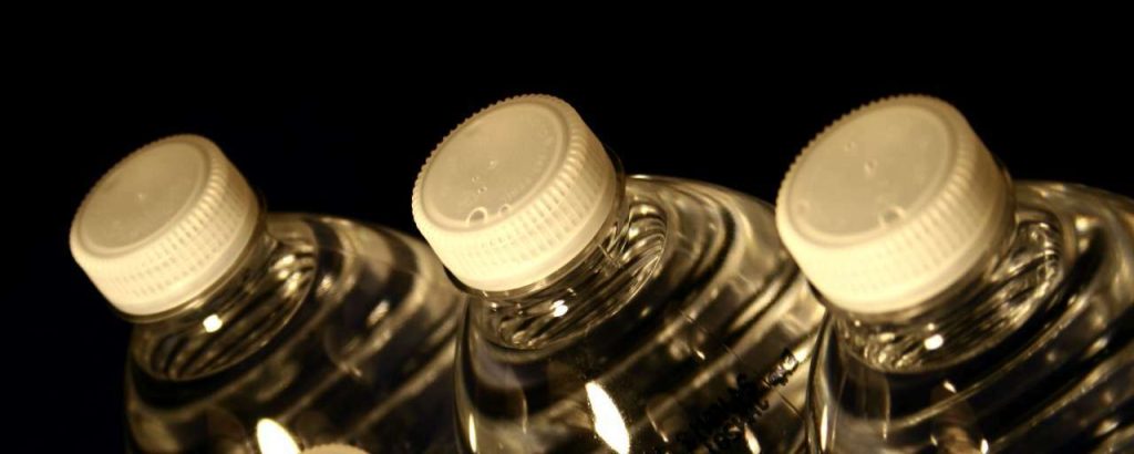 Six plastic bottles filled with spring drinking water