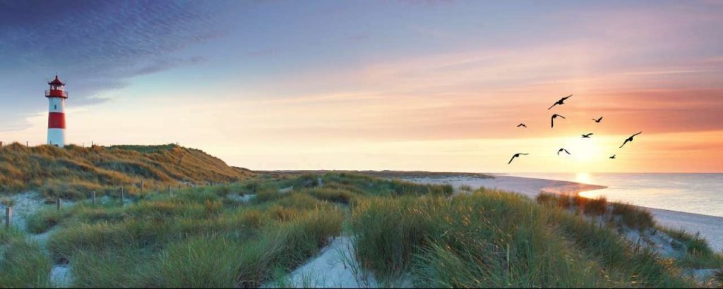 Noordzee panorama ondergaande zon vuurtoren